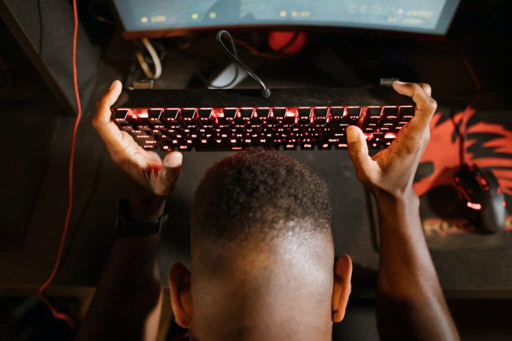 overhead shot of a man holding his mechanical keyboard