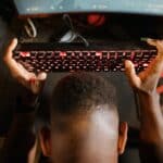 overhead shot of a man holding his mechanical keyboard