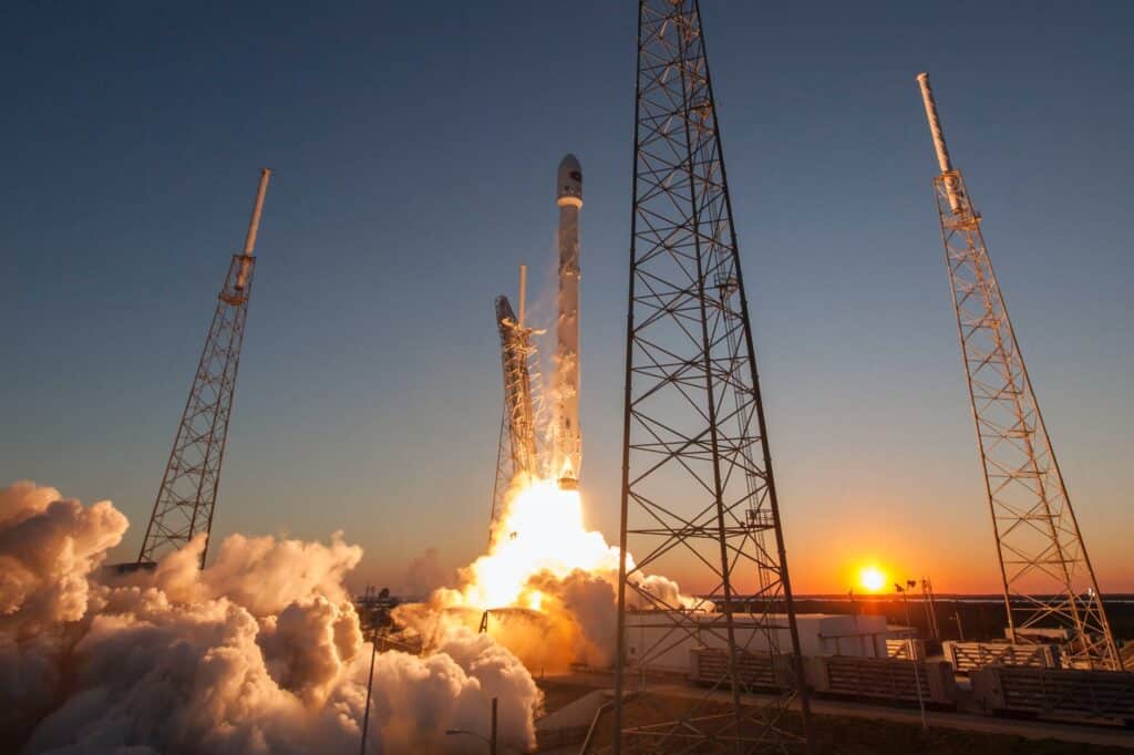 spacecraft launching into orbit during sundown